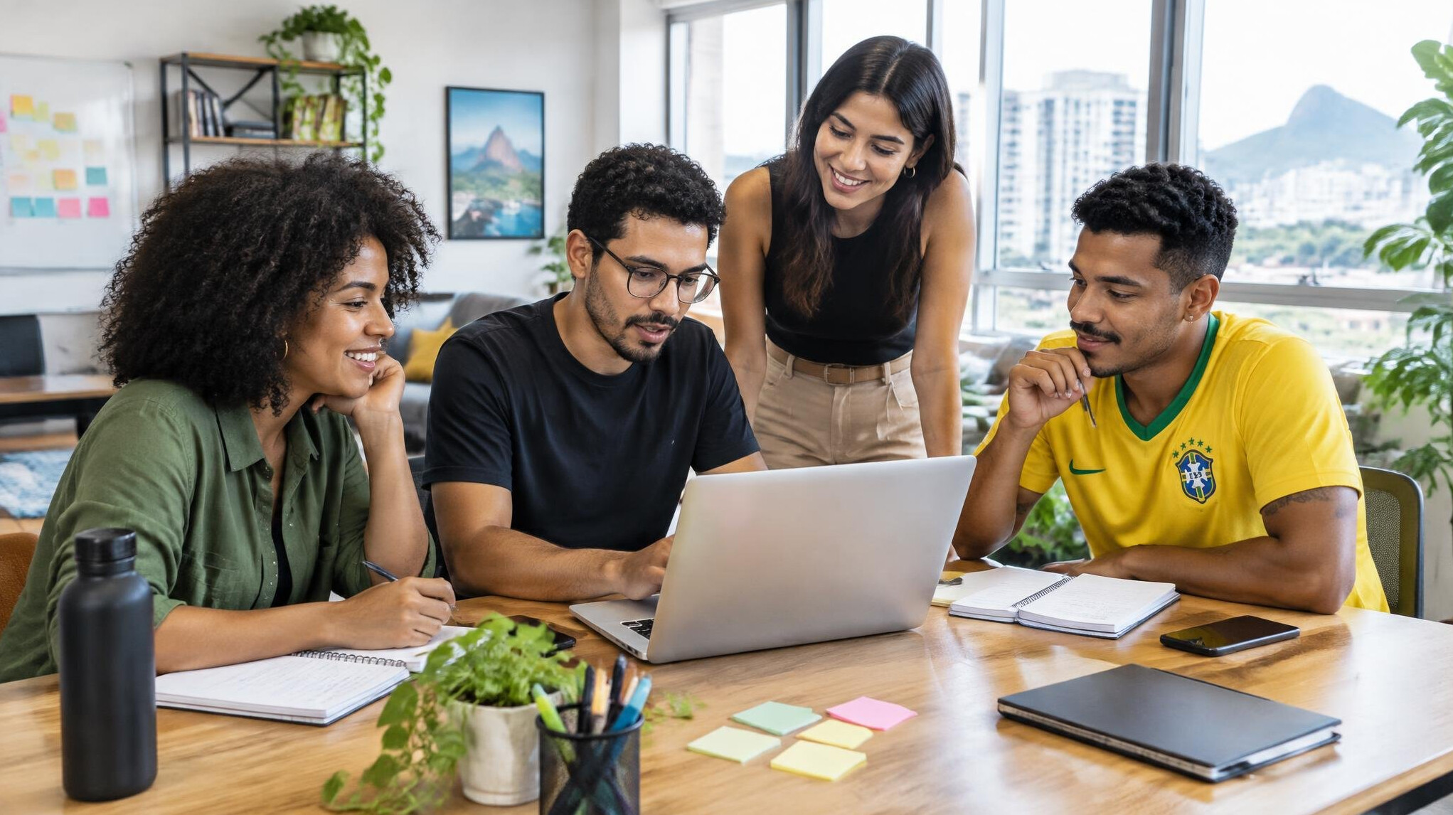 Team collaborating around a laptop