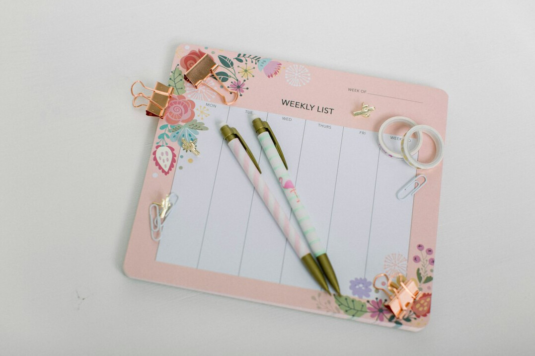 Planner and pen on a desk